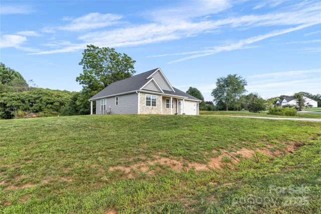 a view of house that has a yard