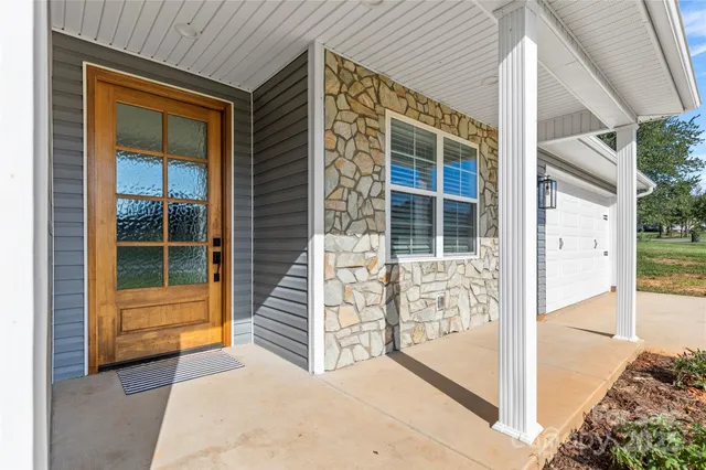a front view of a house with a large window