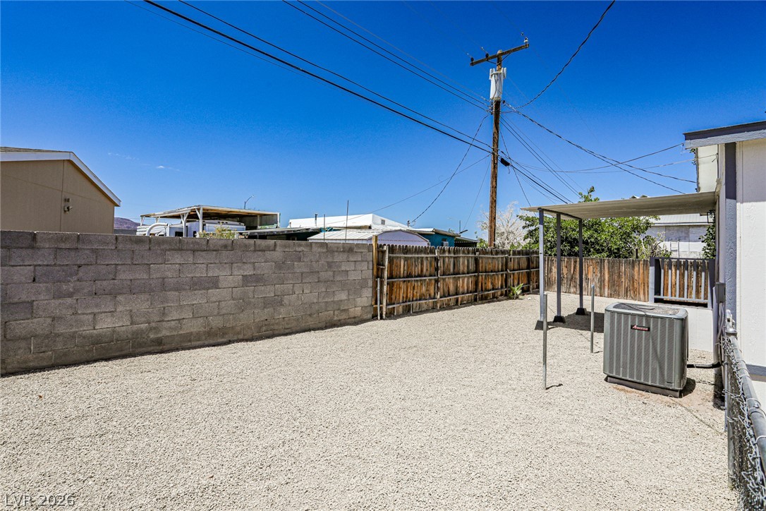 273 Aztec Lane Henderson, NV 89015 - Photo 27 of 28 Gravel yard with solid privacy fencing provides a versatile outdoor space.