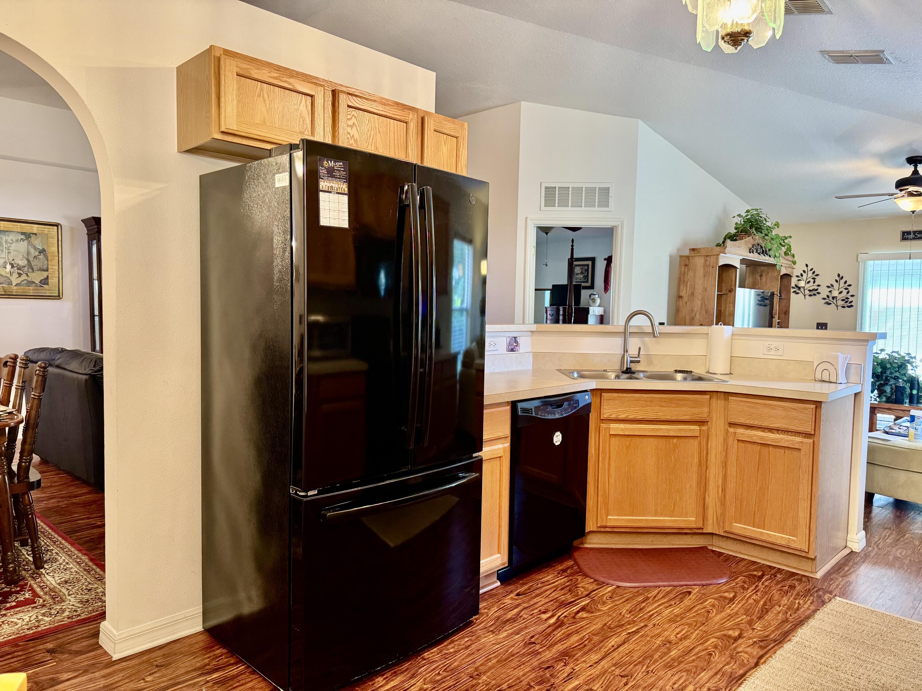527 Southeast 38th Avenue Okeechobee, FL 34974 - Photo 21 of 30 a kitchen with stainless steel appliances a refrigerator and cabinets