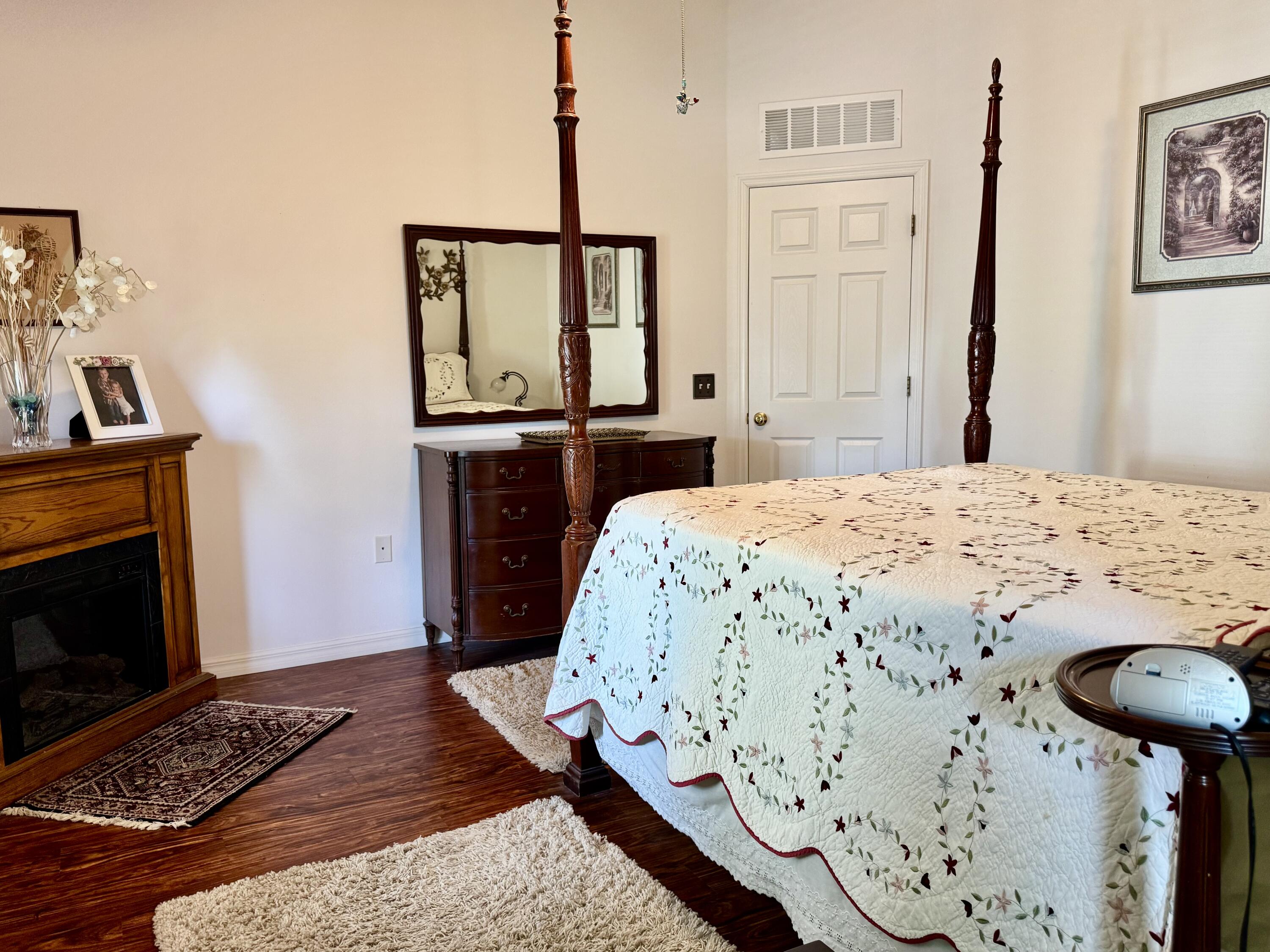 527 Southeast 38th Avenue Okeechobee, FL 34974 - Photo 23 of 30 a bedroom with a bed and a fireplace