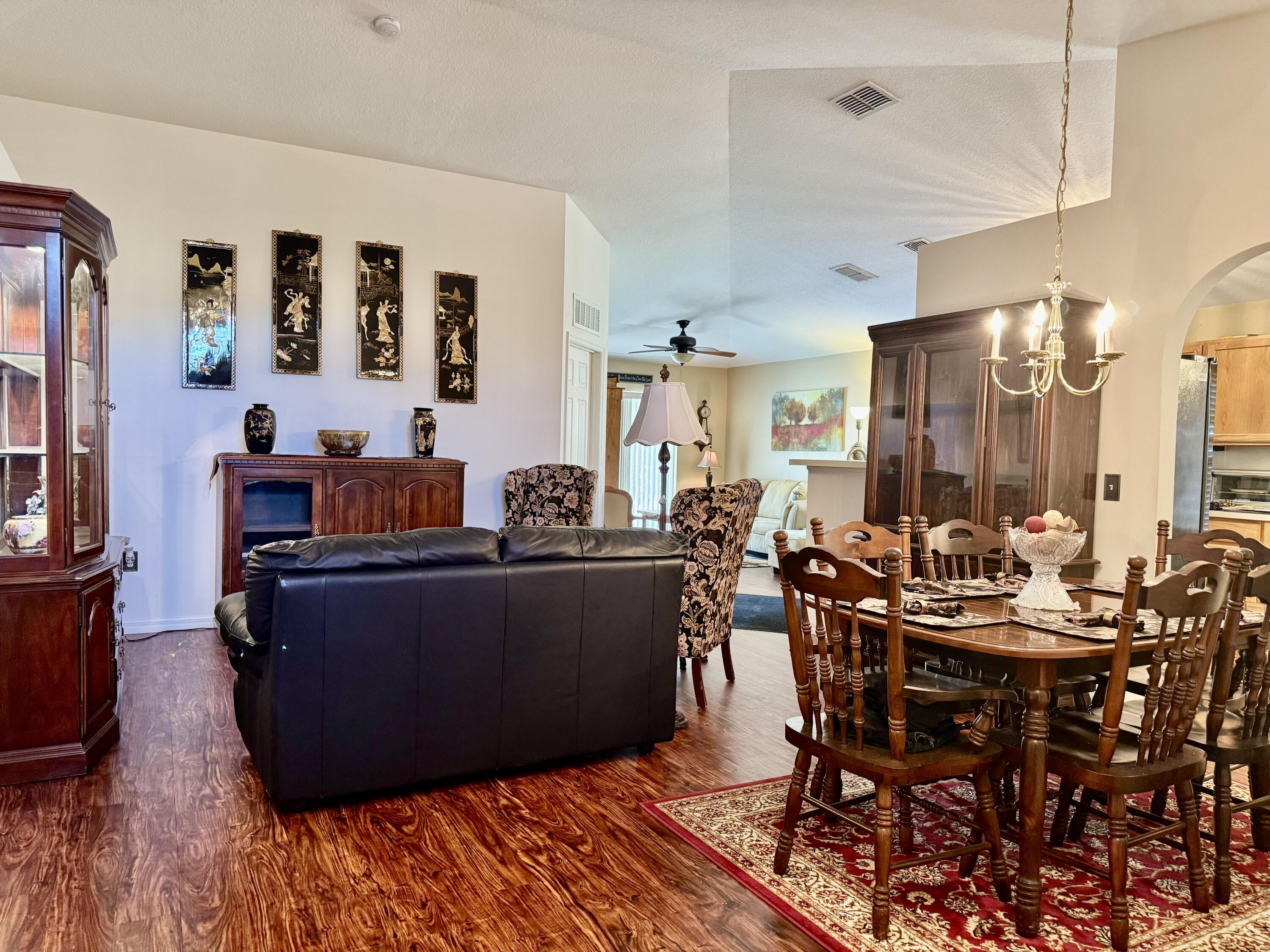 527 Southeast 38th Avenue Okeechobee, FL 34974 - Photo 4 of 30 a living room with furniture and wooden floor