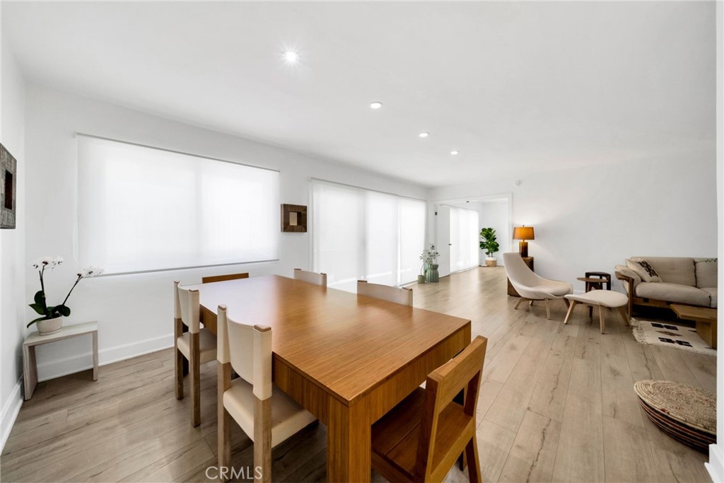 7259 Hillside Avenue, Unit 102 Los Angeles, CA 90046 - Photo 11 of 37 a view of a dining room with furniture and wooden floor
