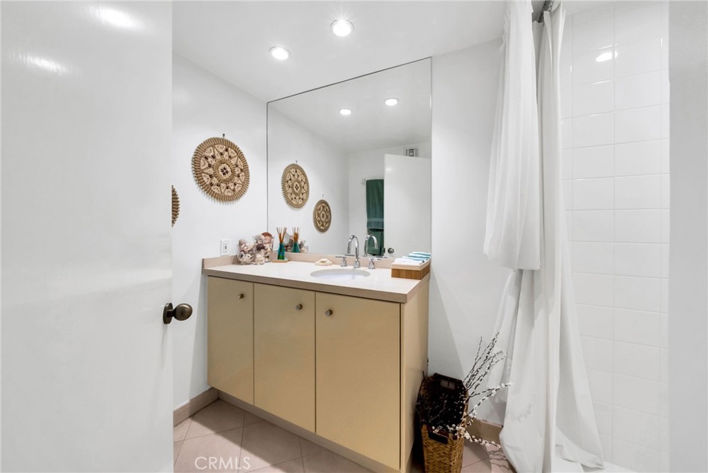 7259 Hillside Avenue, Unit 102 Los Angeles, CA 90046 - Photo 17 of 37 a bathroom with a sink and a mirror