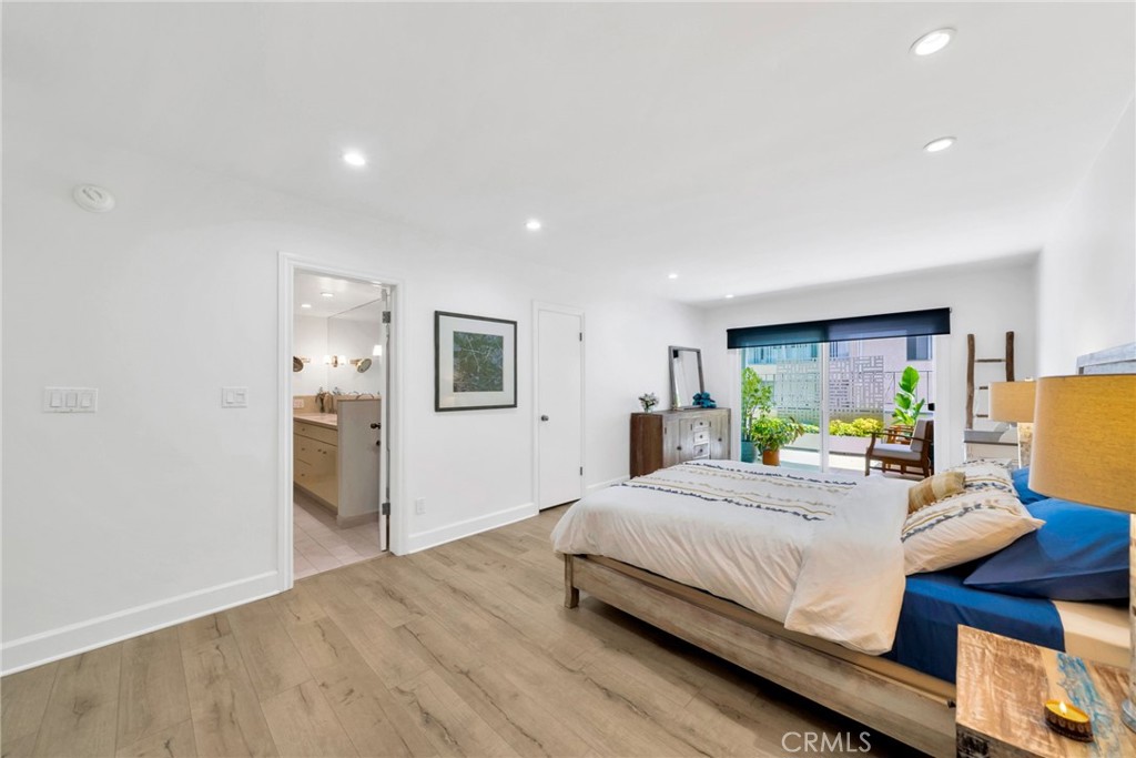 7259 Hillside Avenue, Unit 102 Los Angeles, CA 90046 - Photo 23 of 37 a bedroom with a bed and large windows