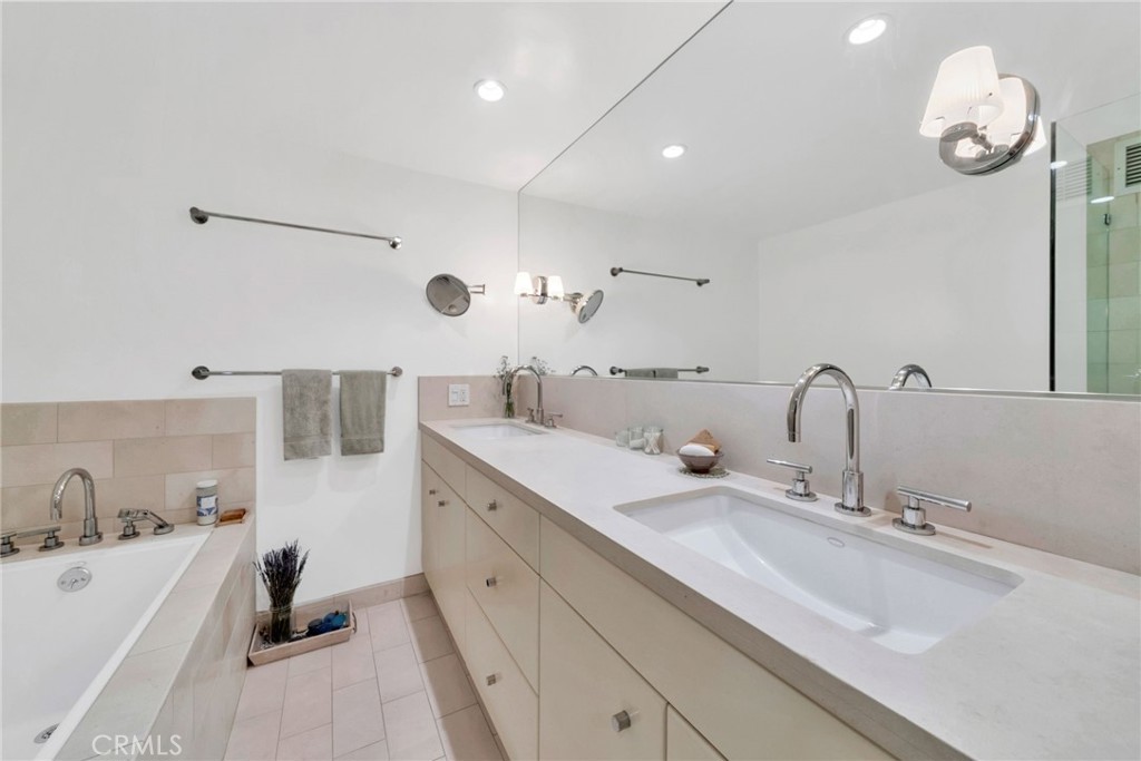 7259 Hillside Avenue, Unit 102 Los Angeles, CA 90046 - Photo 27 of 37 a spacious bathroom with double sink and a mirror