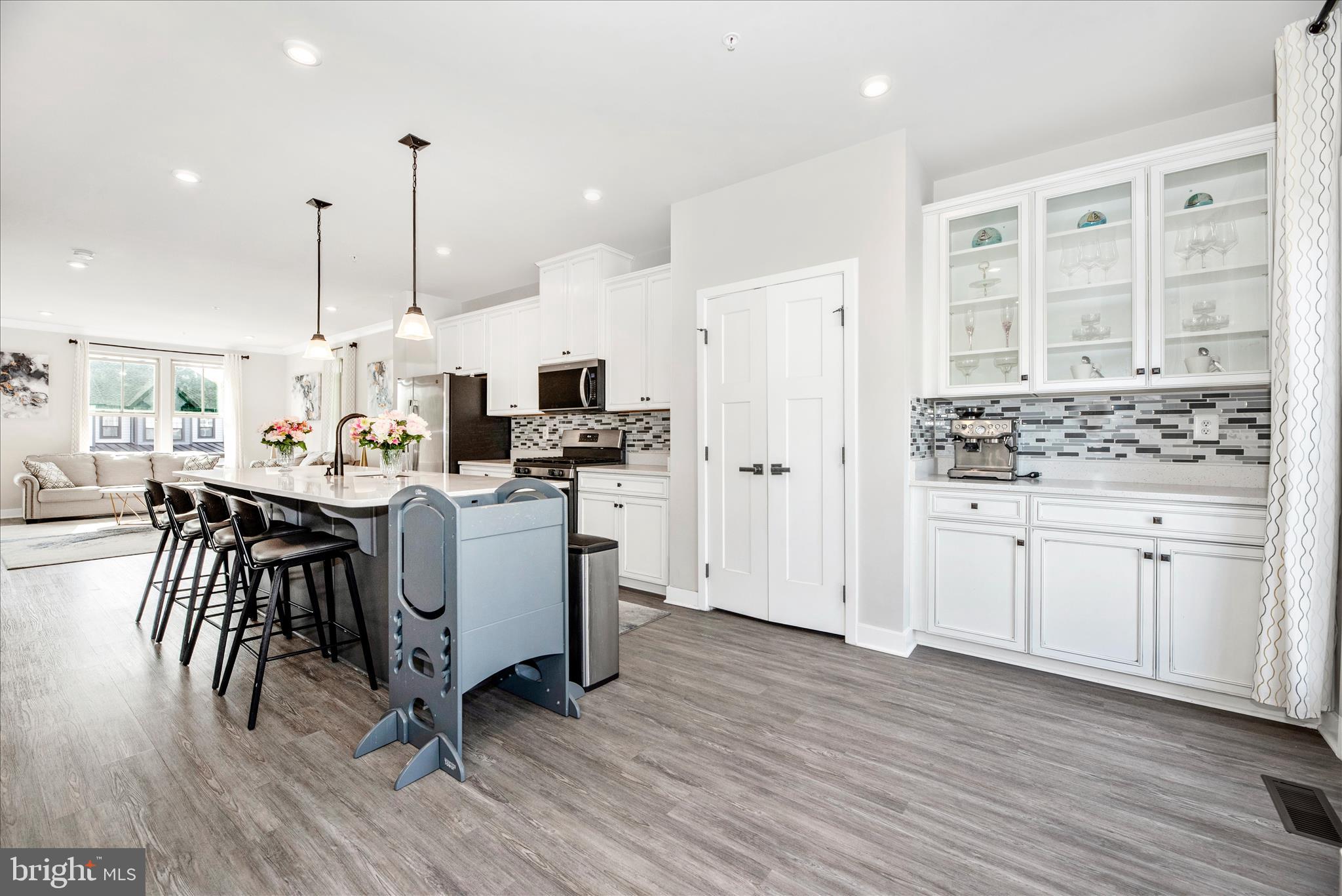 6042 Fallfish Court New Market, MD 21774 - Photo 22 of 77 a kitchen with kitchen island white cabinets and stainless steel appliances