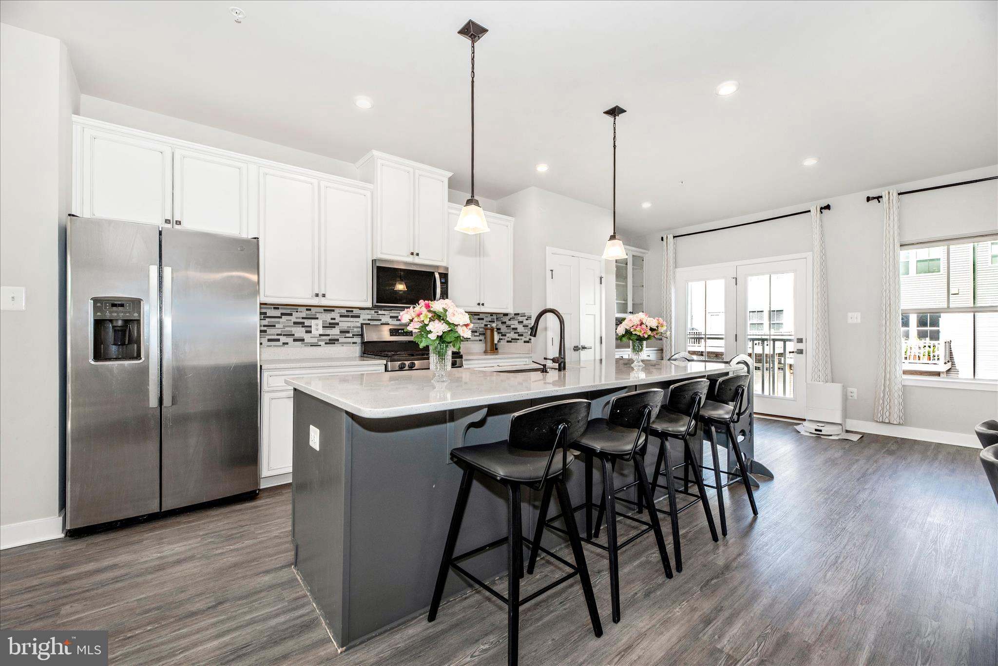 6042 Fallfish Court New Market, MD 21774 - Photo 24 of 77 a kitchen with stainless steel appliances granite countertop a table chairs stove and kitchen island