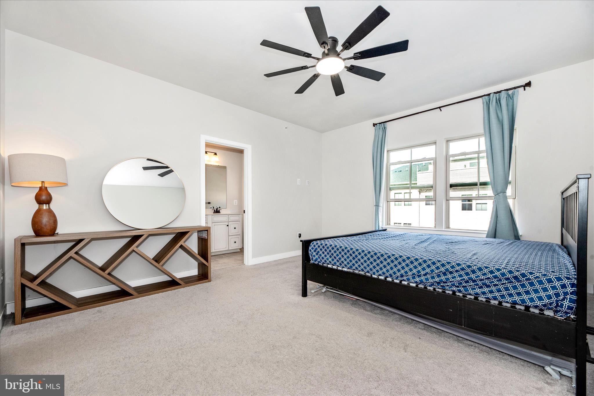 6042 Fallfish Court New Market, MD 21774 - Photo 28 of 77 a bedroom with a bed a window and a chandelier
