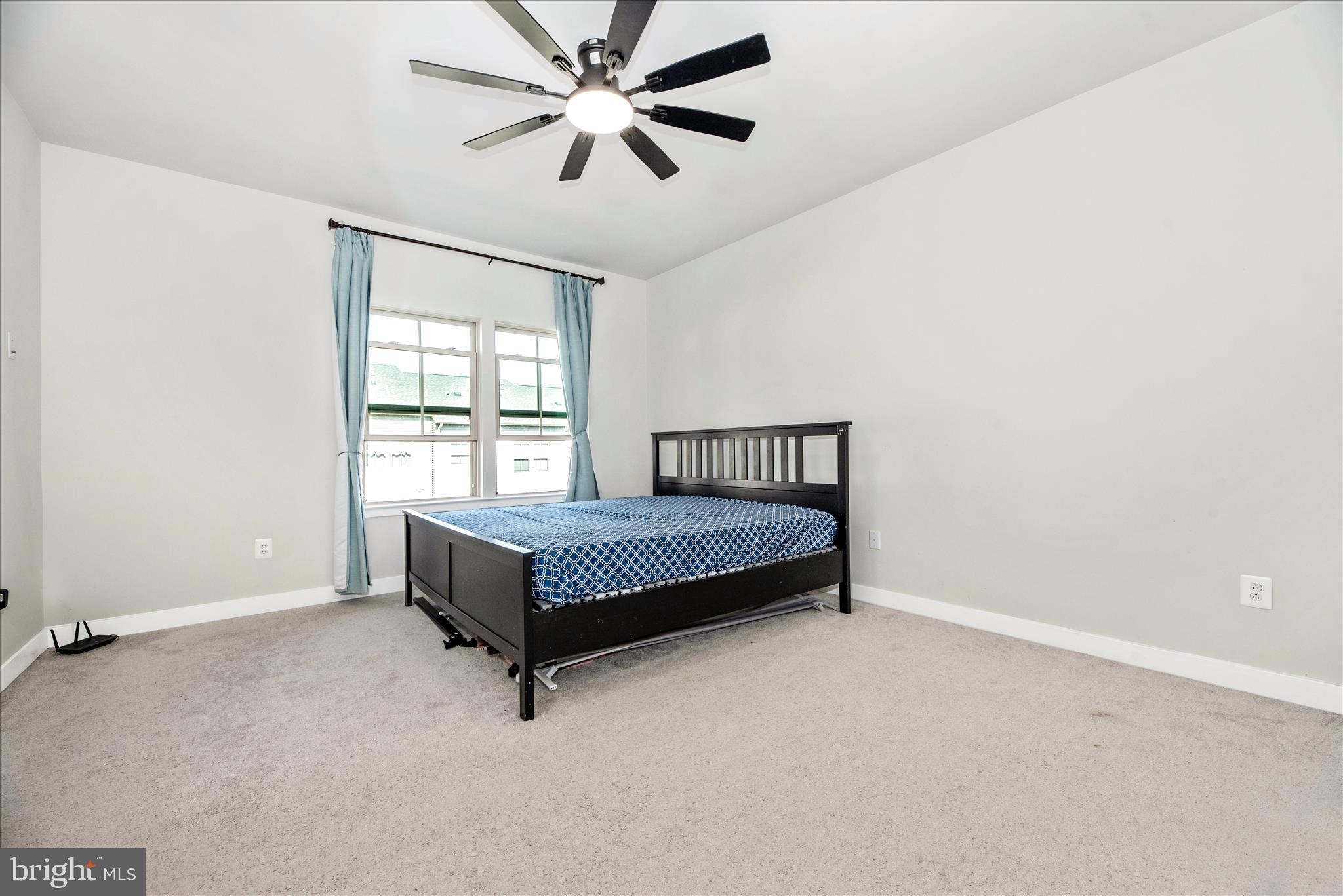 6042 Fallfish Court New Market, MD 21774 - Photo 29 of 77 a spacious bedroom with a bed and a chandelier
