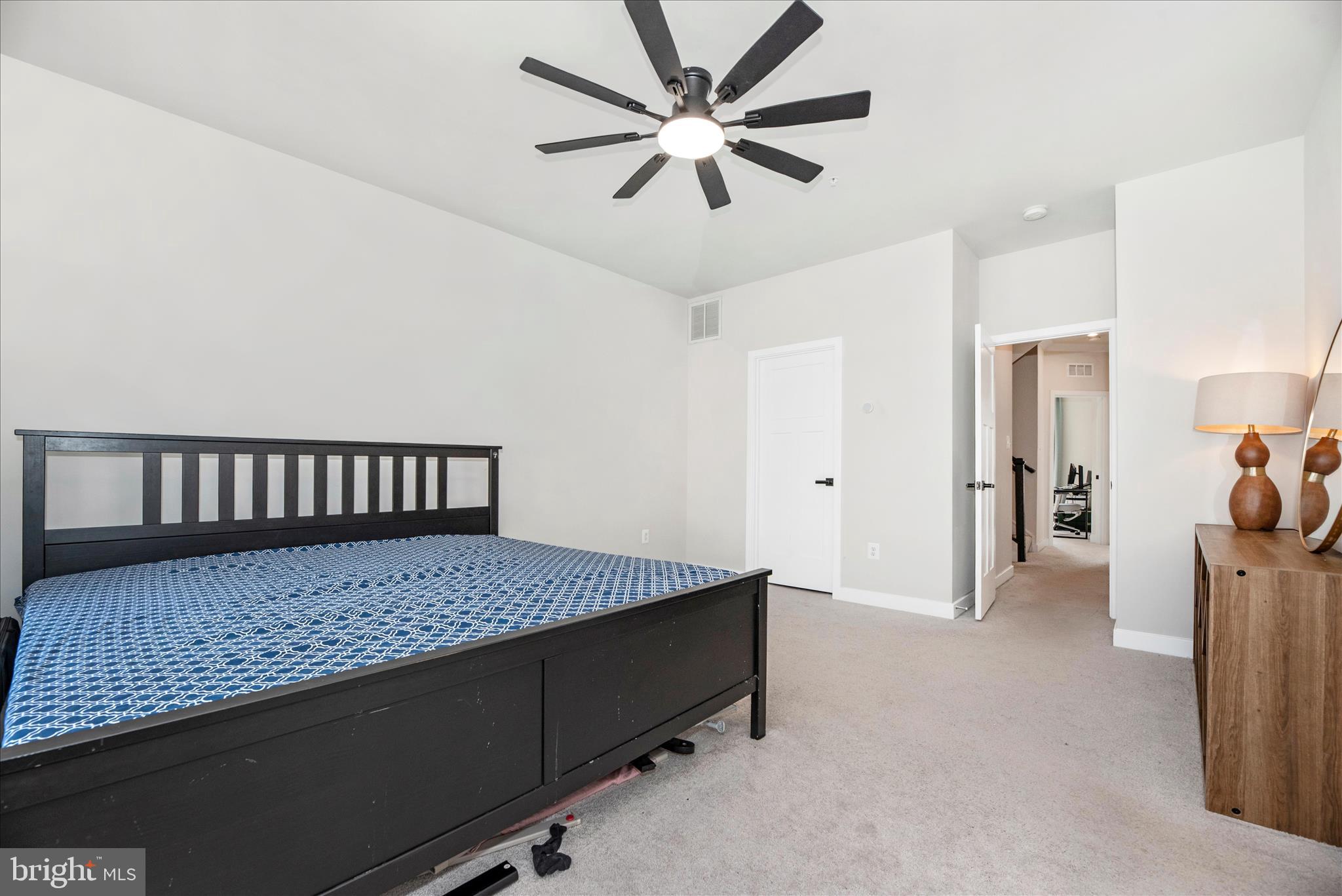 6042 Fallfish Court New Market, MD 21774 - Photo 30 of 77 a bedroom with a bed and a chandelier
