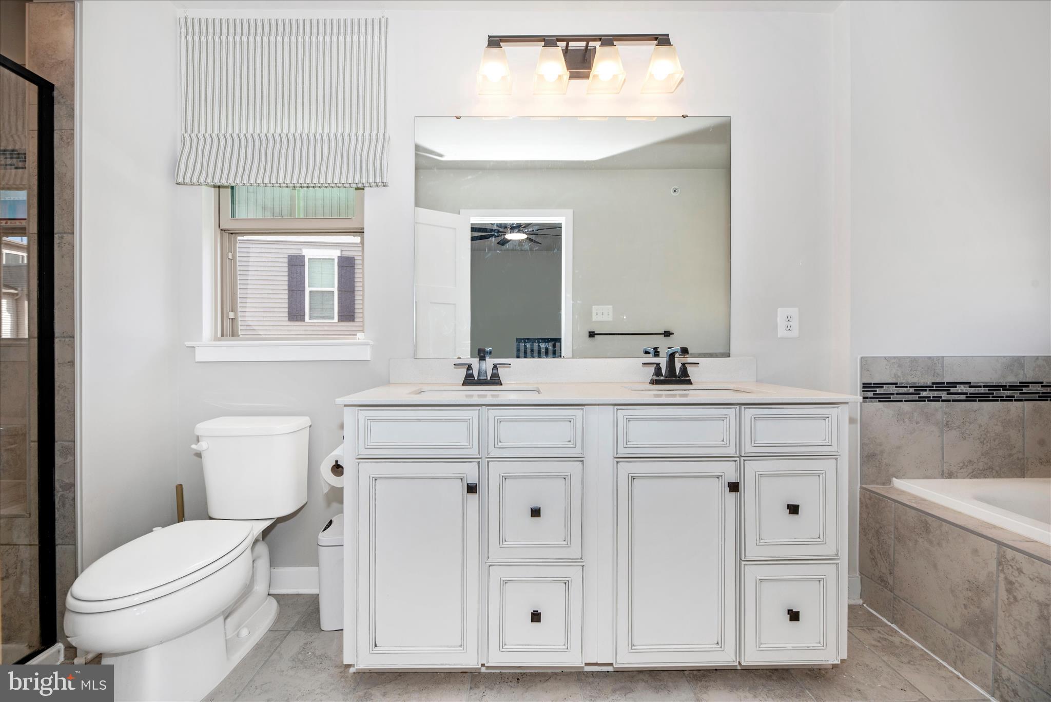 6042 Fallfish Court New Market, MD 21774 - Photo 31 of 77 a bathroom with a sink vanity mirror and toilet