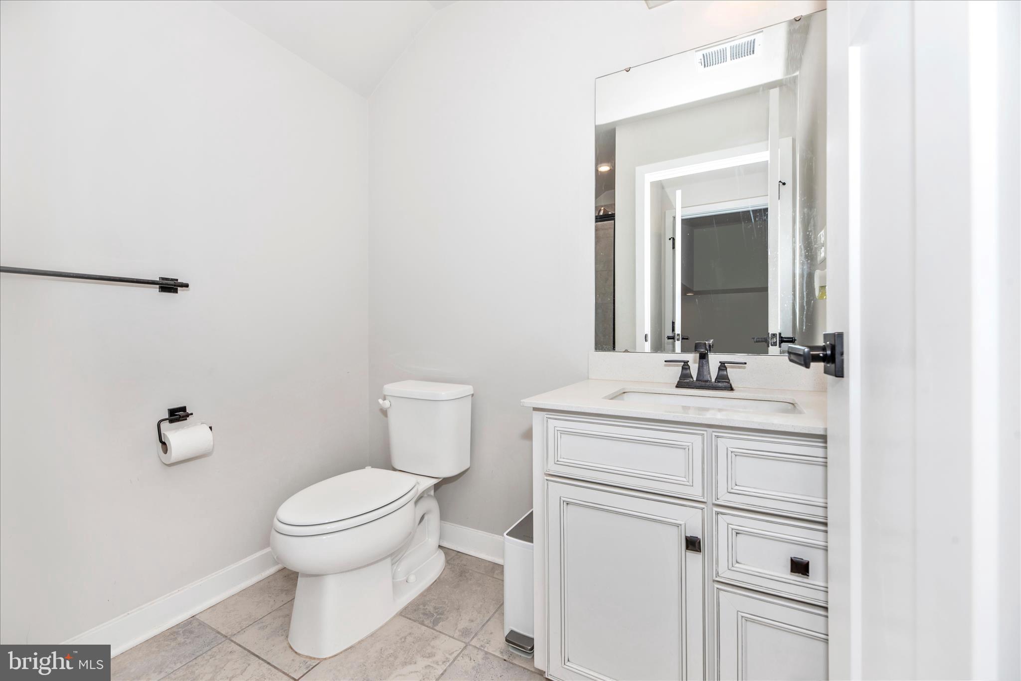 6042 Fallfish Court New Market, MD 21774 - Photo 41 of 77 a bathroom with a toilet a sink a vanity and mirror