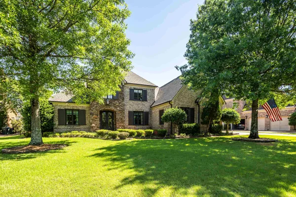 a front view of house with yard and green space