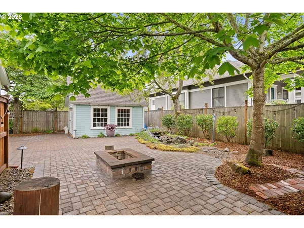 front view of a house with a tree in a yard