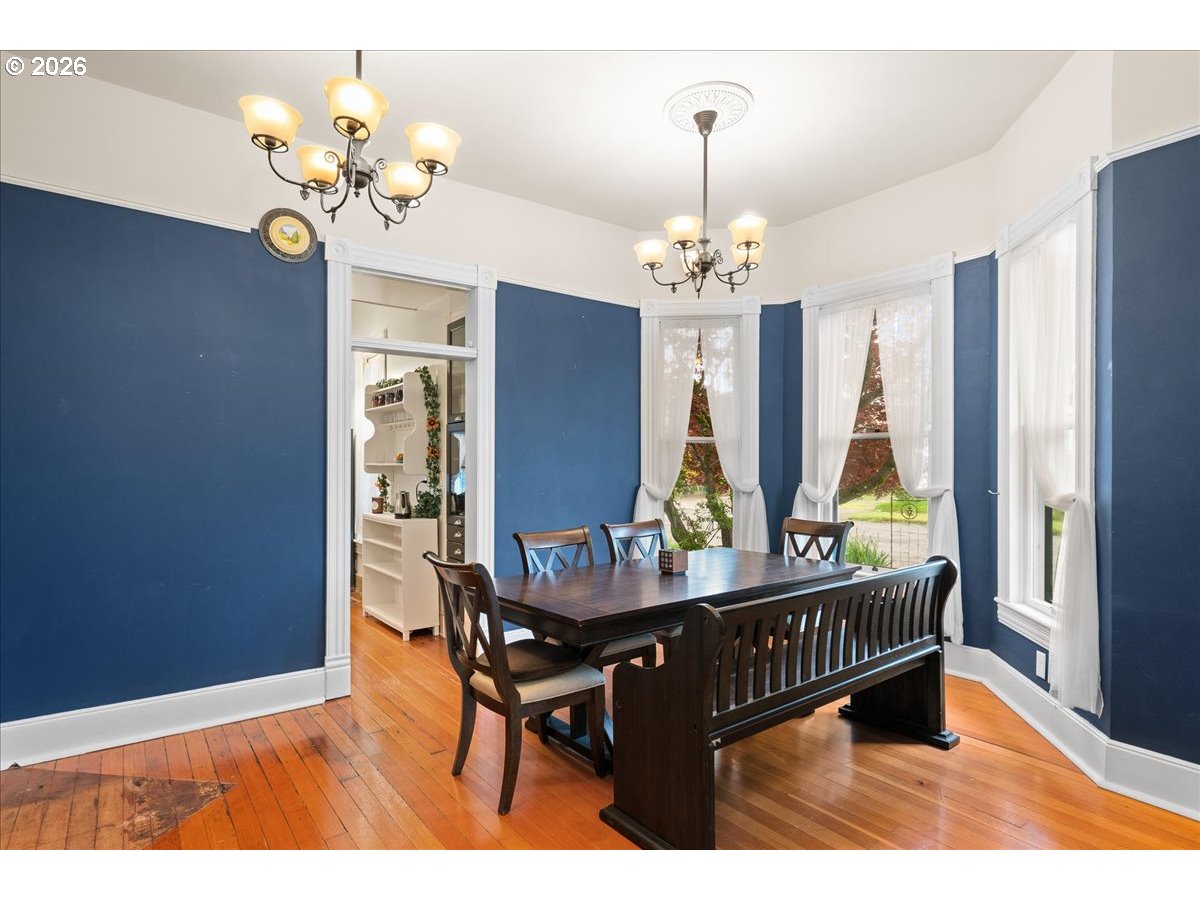 728 6th Avenue Southwest Albany, OR 97321 - Photo 10 of 47 a view of a dining room with furniture a chandelier and wooden floor