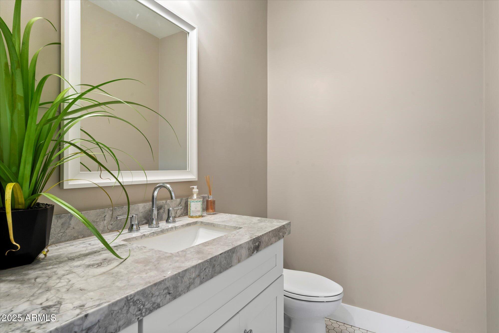 3810 East Devonshire Avenue Phoenix, AZ 85018 - Photo 24 of 34 a bathroom with a granite countertop sink and a toilet