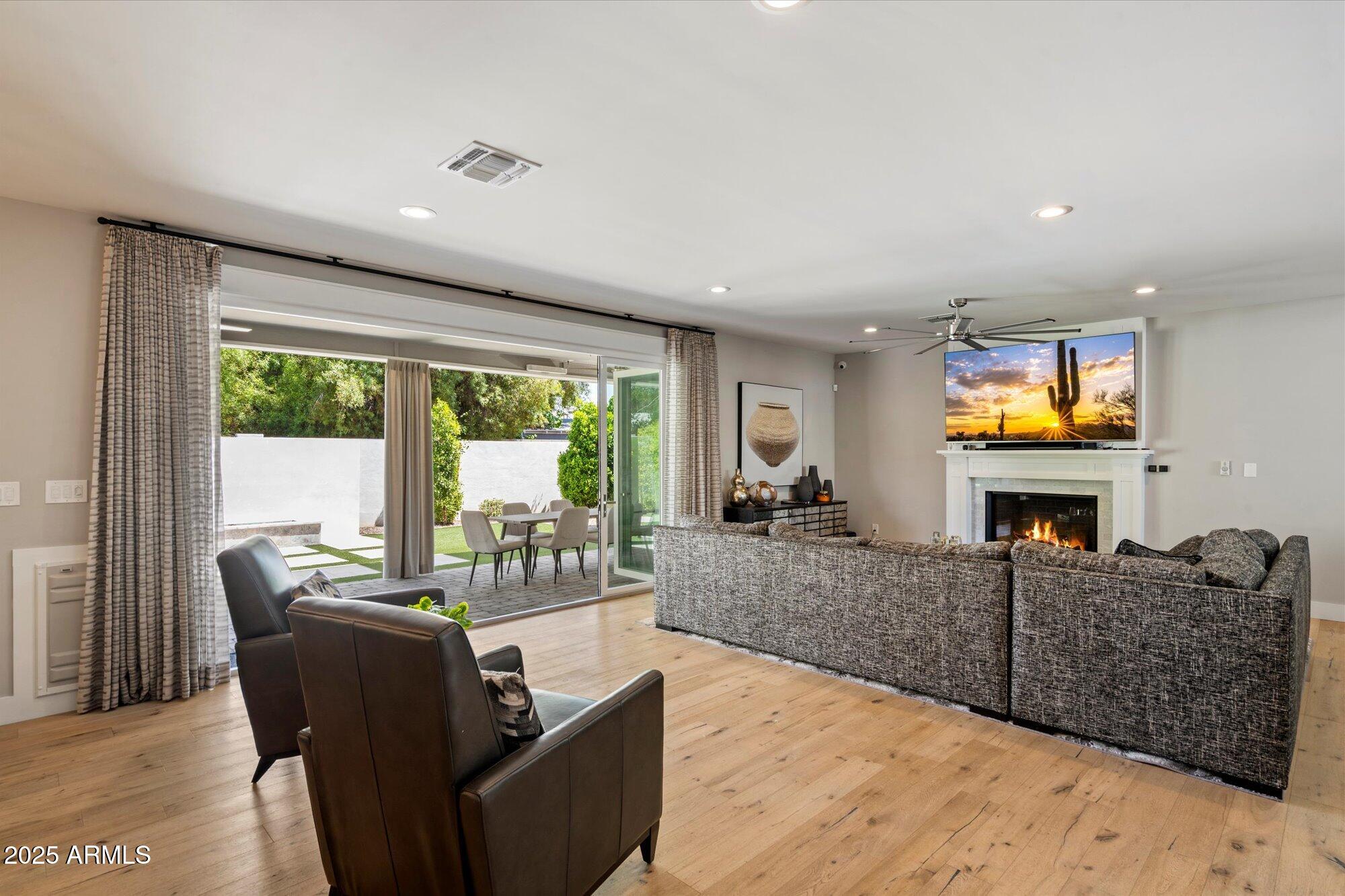 3810 East Devonshire Avenue Phoenix, AZ 85018 - Photo 6 of 34 a living room with furniture and a flat screen tv