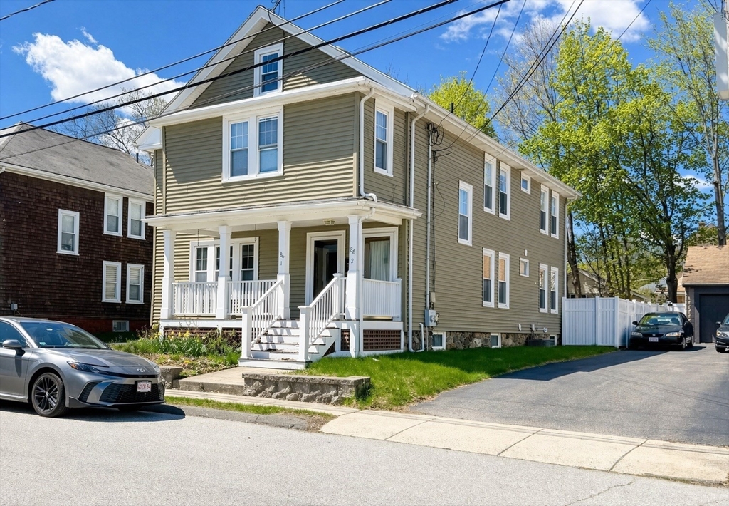86 Howard Street, Unit 1 Waltham, MA 02451 - Photo 2 of 22 a car parked in front of a house