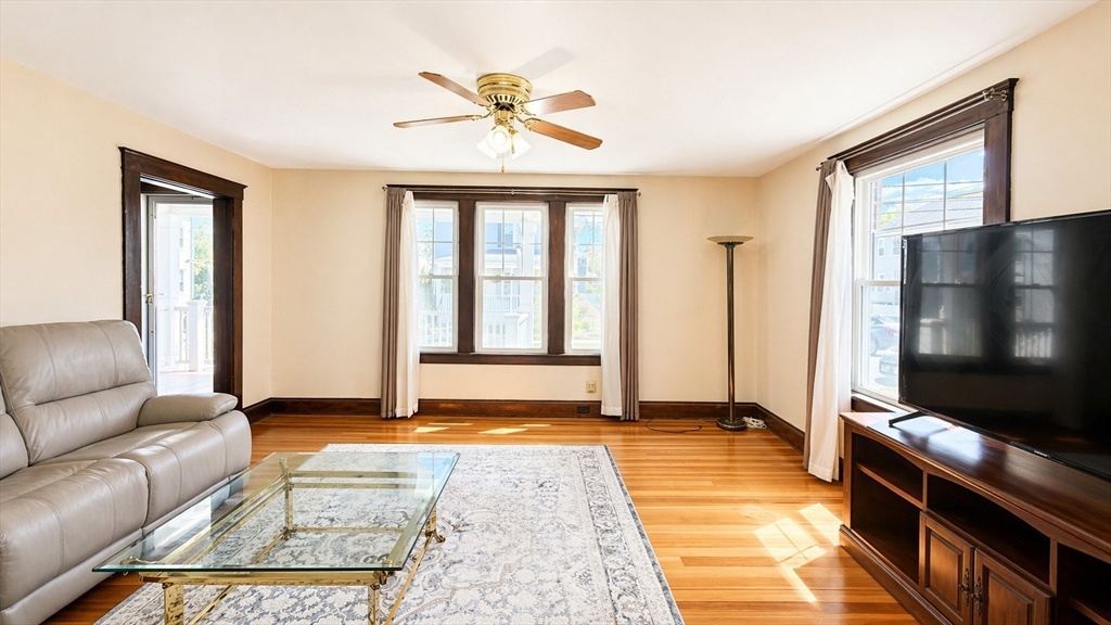 86 Howard Street, Unit 1 Waltham, MA 02451 - Photo 3 of 22 a living room with a flat screen tv and a window