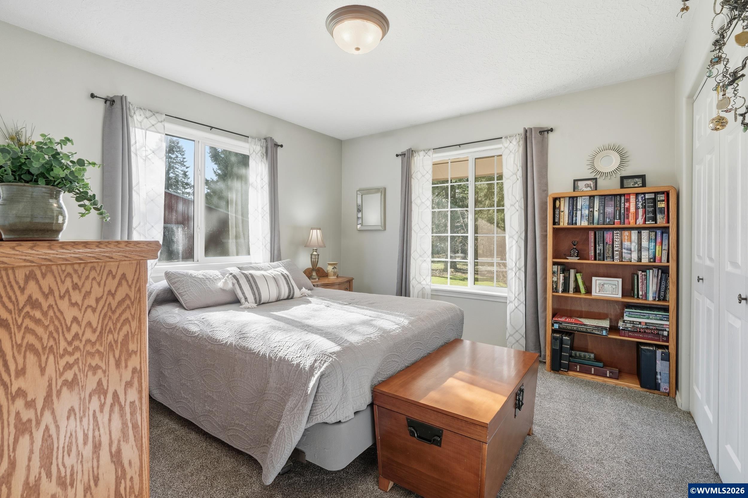 1110 Reuben Boise Road Dallas, OR 97338 - Photo 26 of 49 a bedroom with a bed bookshelf and a large window
