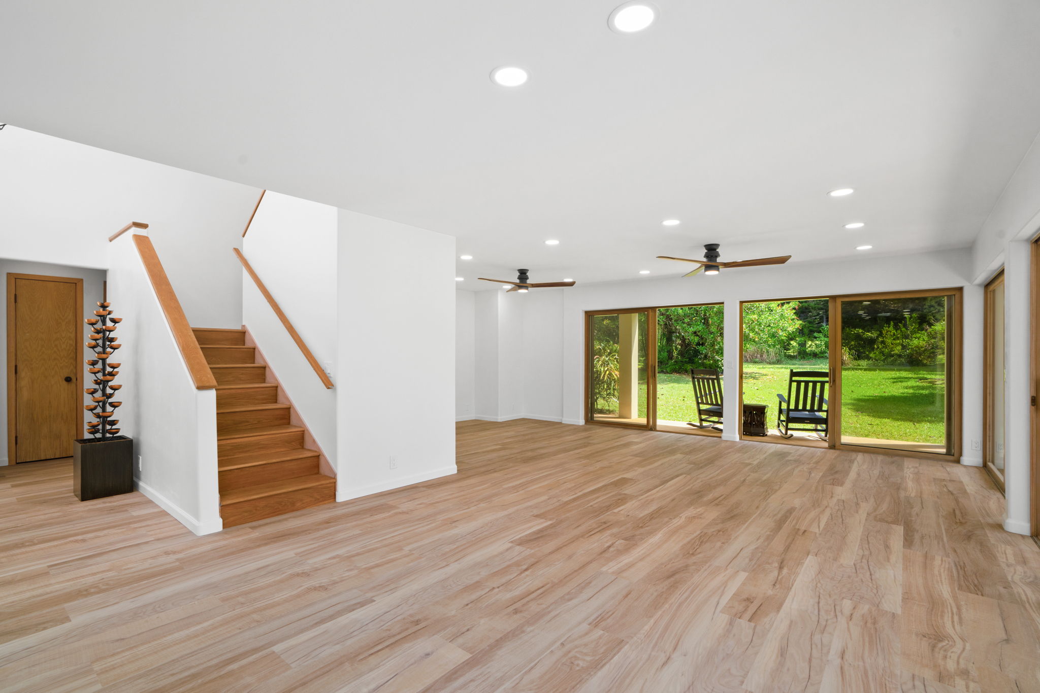4179 Liholiho Road Princeville, HI 96722 - Photo 15 of 30 a view of an empty room with wooden floor fridge and a large window