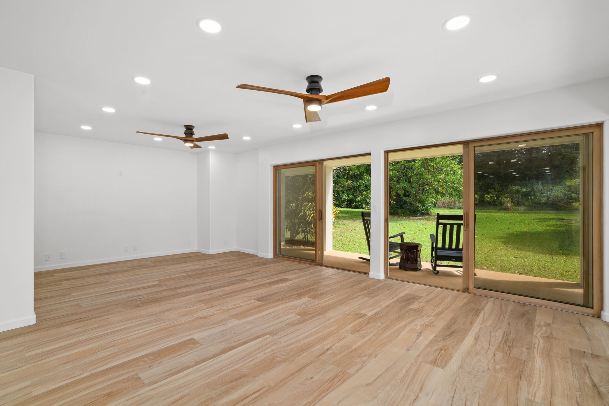 4179 Liholiho Road Princeville, HI 96722 - Photo 19 of 30 an empty room with wooden floor and outdoor view