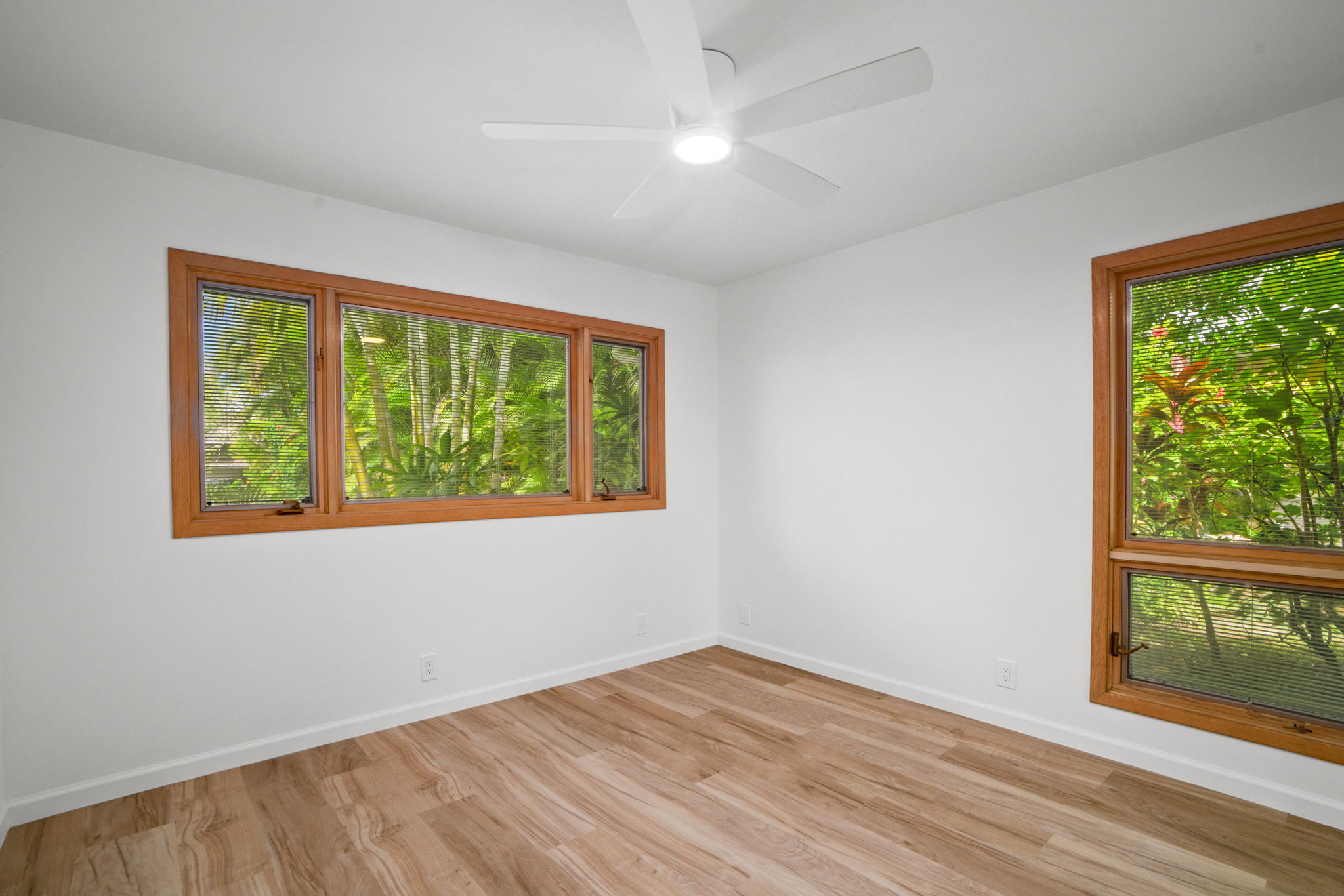4179 Liholiho Road Princeville, HI 96722 - Photo 22 of 30 a view of an empty room with wooden floor and a window