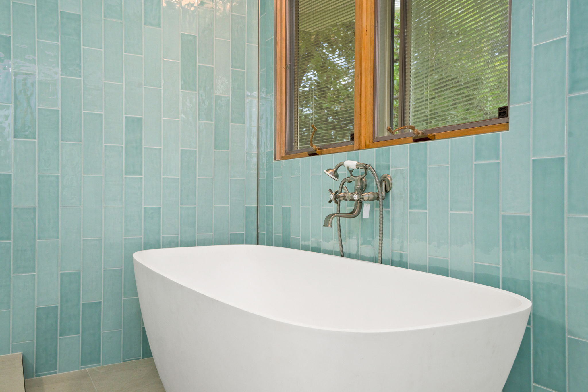 4179 Liholiho Road Princeville, HI 96722 - Photo 10 of 30 a white bath tub sitting in a bathroom next to a window