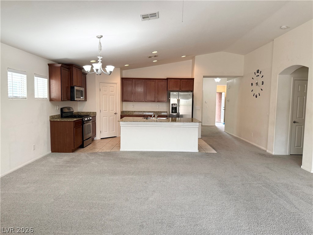 8231 Buffalo Ranch Avenue Las Vegas, NV 89147 - Photo 22 of 22 An open floorplan seamlessly connects the well-appointed kitchen to a generous living area.
