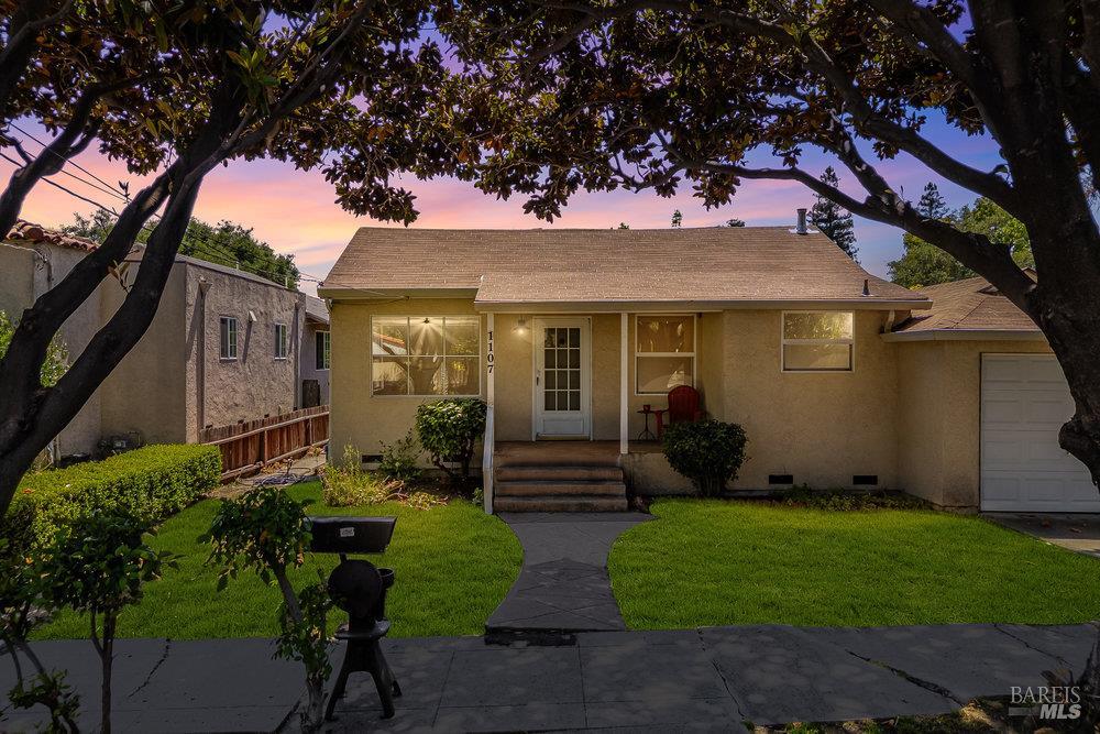 a front view of a house with garden
