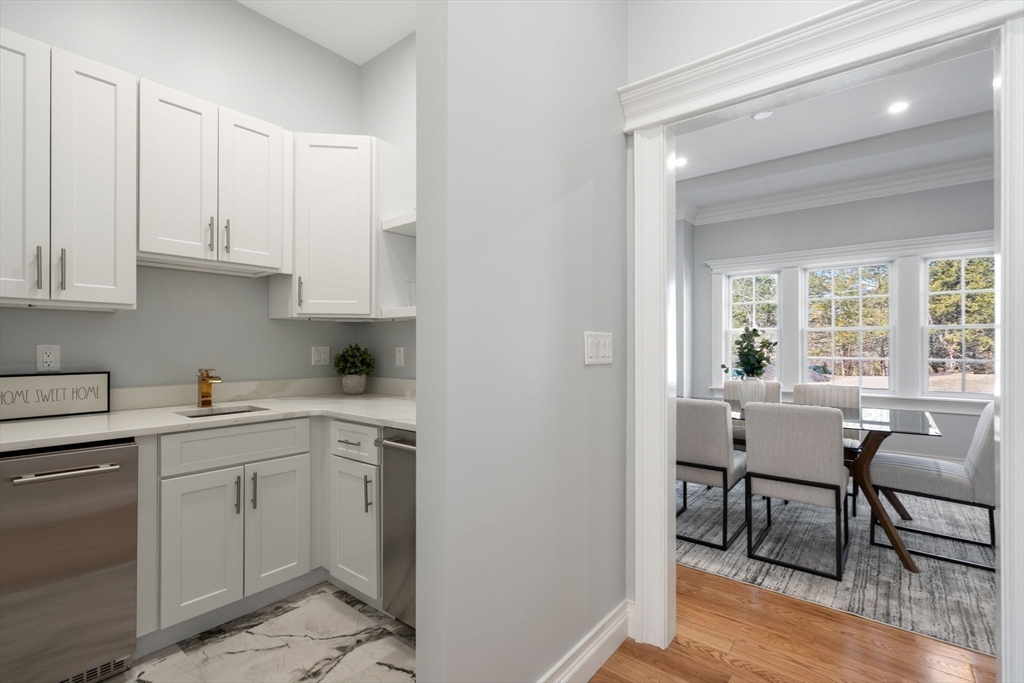 10 Hitching Post Lane Weston, MA 02493 - Photo 8 of 42 a kitchen with a white cabinets and chairs in it