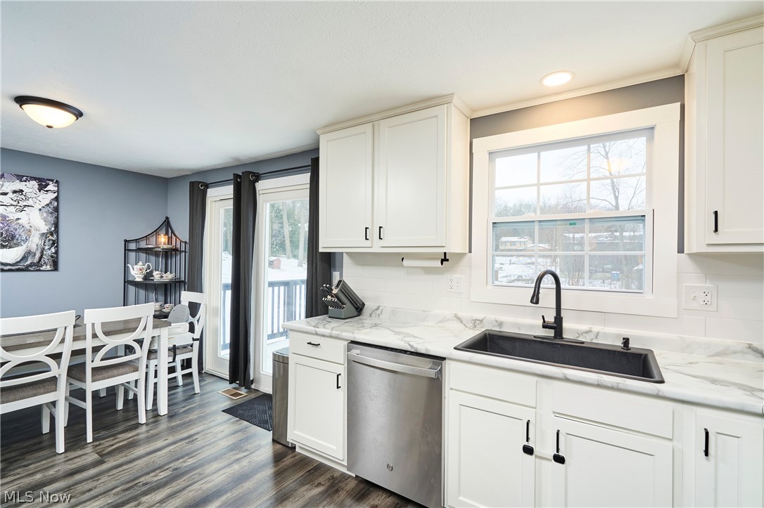 6300 South Cleveland Massillon Road Clinton, OH 44216 - Photo 5 of 22 Kitchen featuring dishwasher, LVP Flooring, white cabinetry,