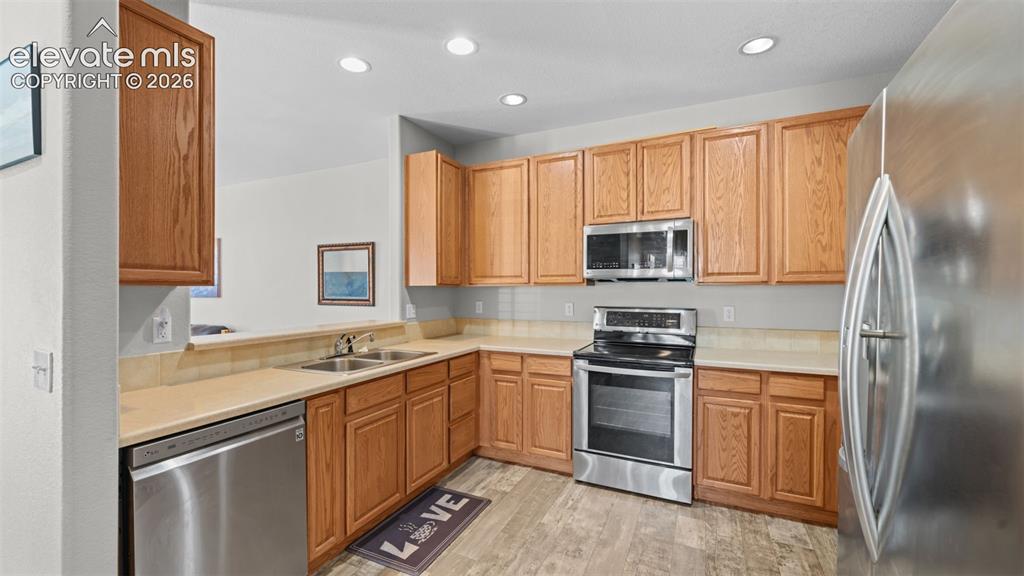 4023 Diamond Ridge View Colorado Springs, CO 80918 - Photo 12 of 31 a kitchen with a sink stove and refrigerator