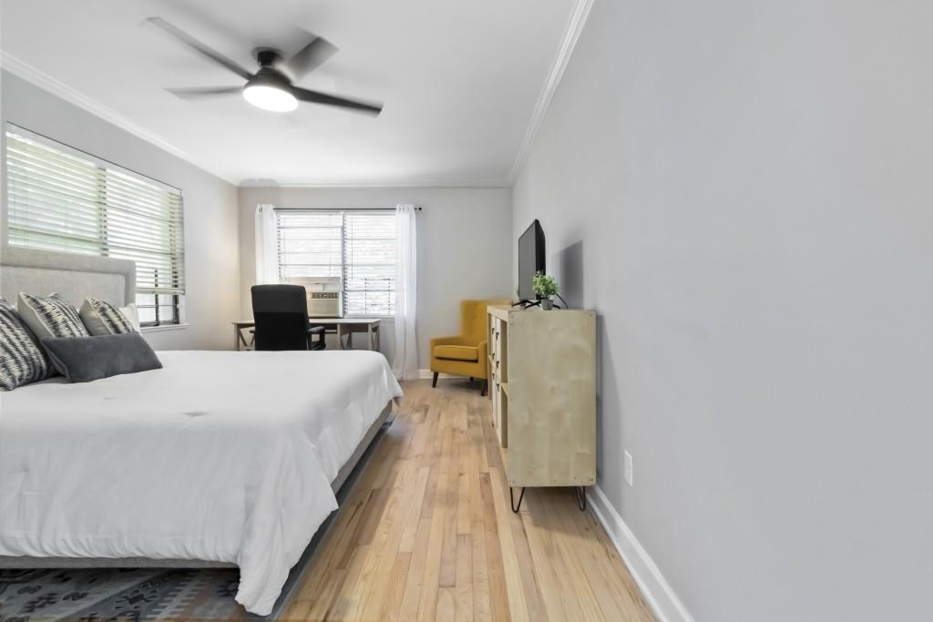 816 Piedmont Avenue Northeast, Unit 1 Atlanta, GA 30308 - Photo 11 of 21 a spacious bedroom with a bed and wooden floor