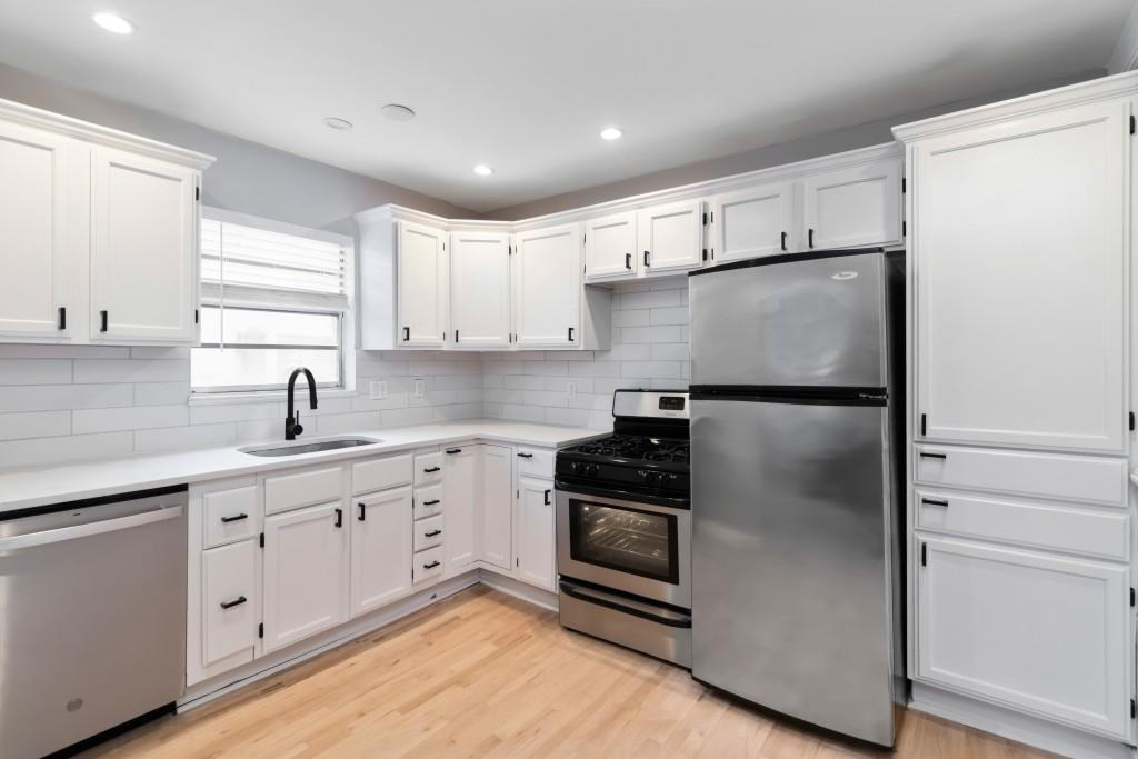 816 Piedmont Avenue Northeast, Unit 1 Atlanta, GA 30308 - Photo 3 of 21 a kitchen with a refrigerator sink and cabinets