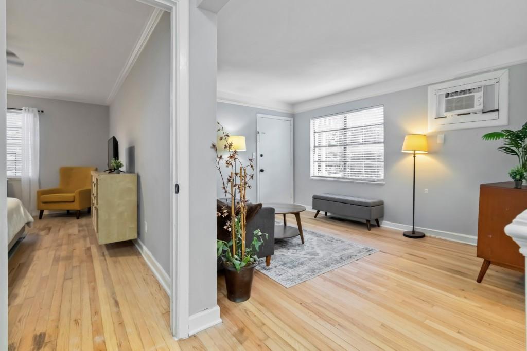 816 Piedmont Avenue Northeast, Unit 1 Atlanta, GA 30308 - Photo 8 of 21 a living room with furniture and a wooden floor