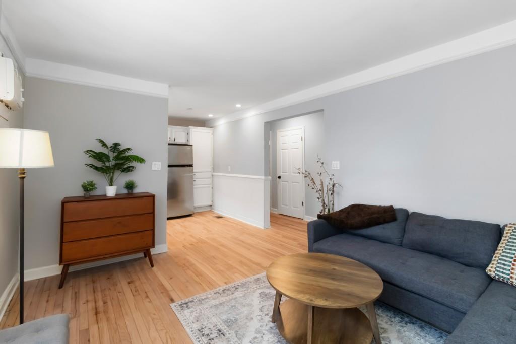 816 Piedmont Avenue Northeast, Unit 1 Atlanta, GA 30308 - Photo 9 of 21 a living room with furniture potted plant and a lamp