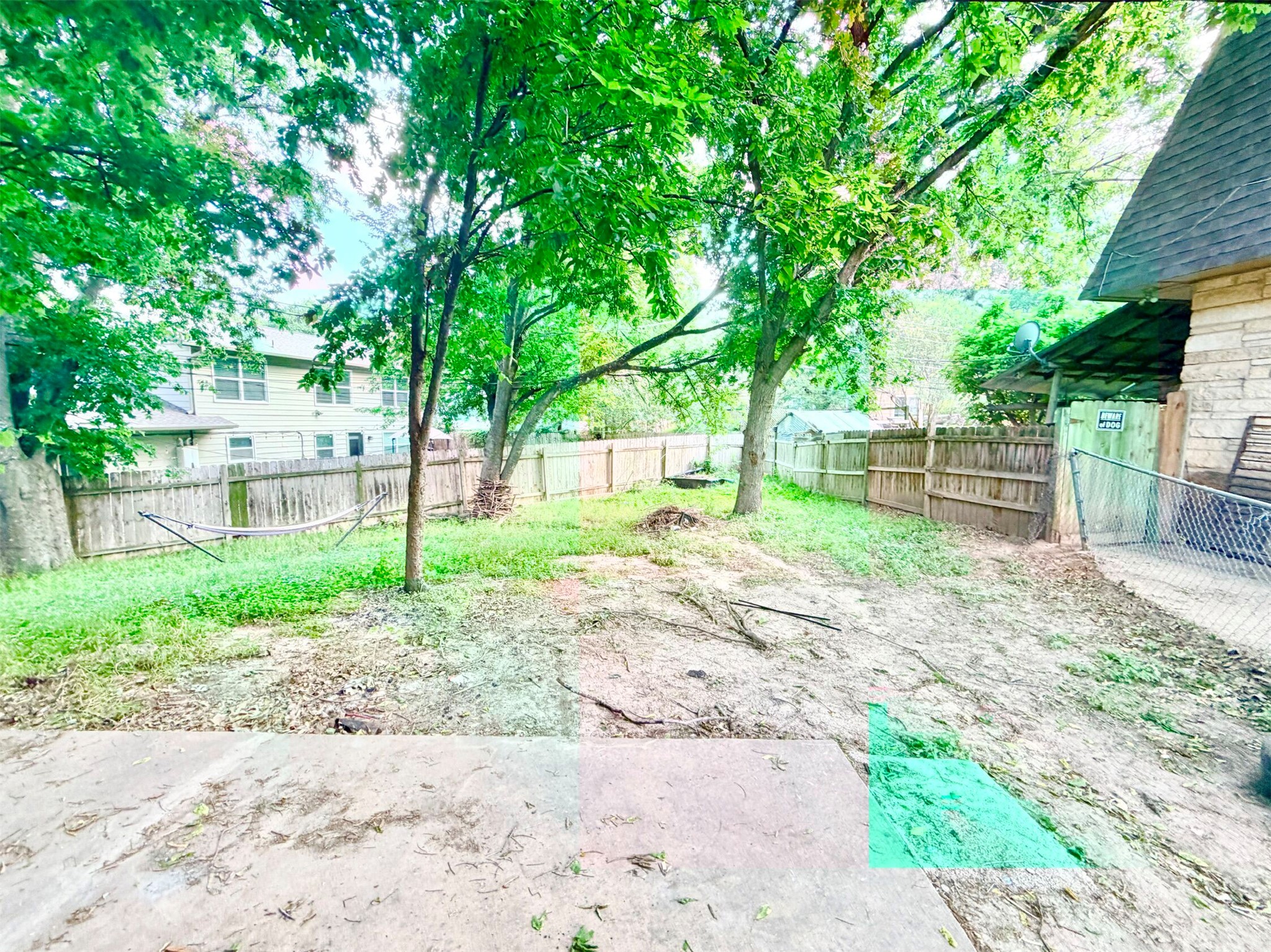 6257 Manor Road, Unit B Austin, TX 78723 - Photo 13 of 38 Expansive outdoor space featuring mature trees and a privacy fence