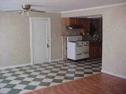 a kitchen with a sink a stove and cabinets