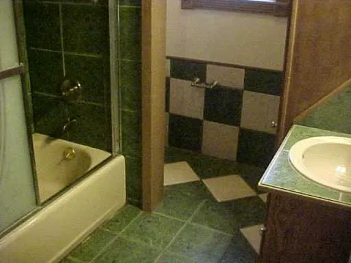 a bathroom with a tub a sink and a toilet