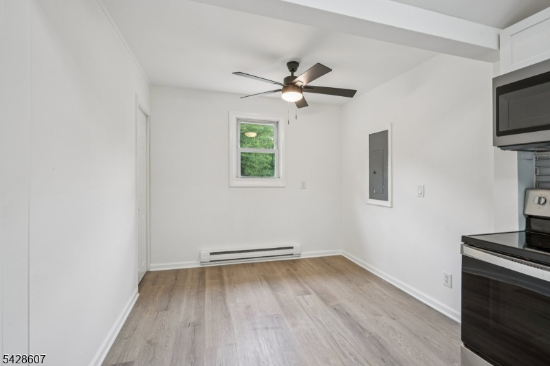 223 Waconia Road Vernon, NJ 07422 - Photo 12 of 26 a view of empty room with wooden floor and fan