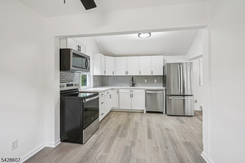223 Waconia Road Vernon, NJ 07422 - Photo 13 of 26 a kitchen with a sink cabinets stainless steel appliances and a window