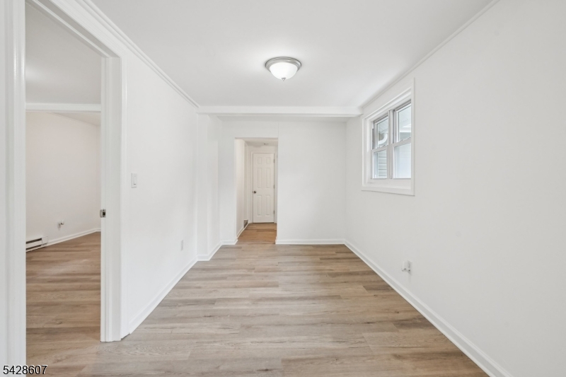 223 Waconia Road Vernon, NJ 07422 - Photo 15 of 26 a view of an empty room with wooden floor