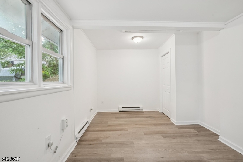 223 Waconia Road Vernon, NJ 07422 - Photo 17 of 26 a view of a room with wooden floor and a window