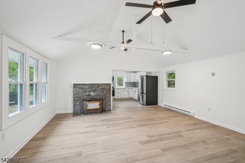 223 Waconia Road Vernon, NJ 07422 - Photo 4 of 26 a view of an empty room with a fireplace and a window