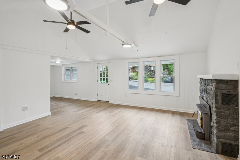 223 Waconia Road Vernon, NJ 07422 - Photo 6 of 26 a view of an empty room with a window and wooden floor