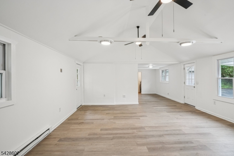 223 Waconia Road Vernon, NJ 07422 - Photo 8 of 26 an empty room with ceiling fan and windows