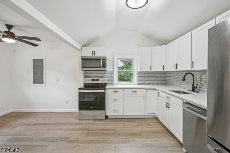 223 Waconia Road Vernon, NJ 07422 - Photo 9 of 26 a kitchen with stainless steel appliances granite countertop a stove and white cabinets