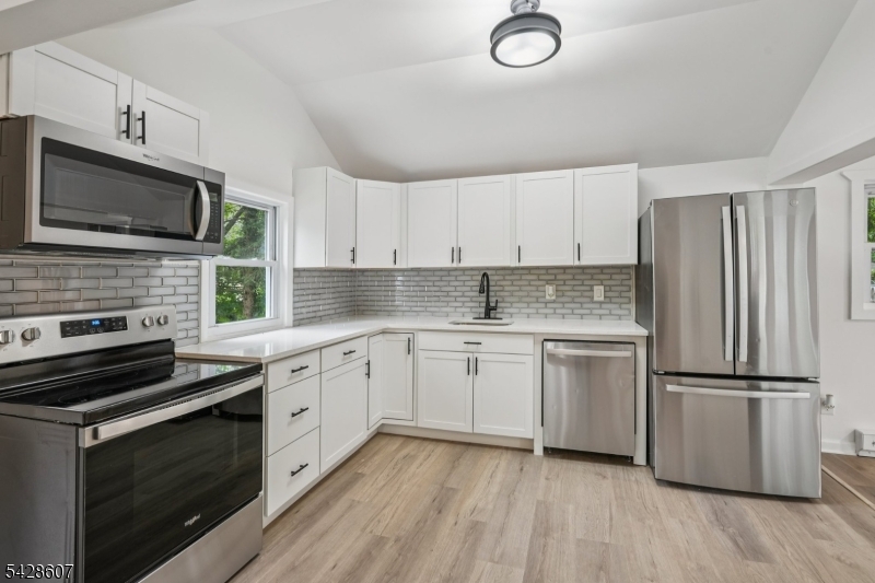 223 Waconia Road Vernon, NJ 07422 - Photo 10 of 26 a kitchen with granite countertop stainless steel appliances and wooden cabinets